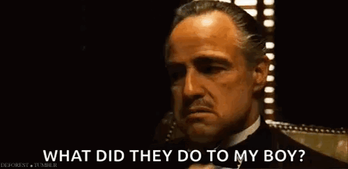 A Man In A Suit And Tie Is Talking On A Cell Phone And Asking What Did They Do To My Boy . GIF