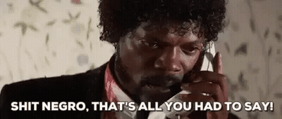 A Man In A Suit And Tie Is Talking On A Cell Phone And Making A Funny Face . GIF