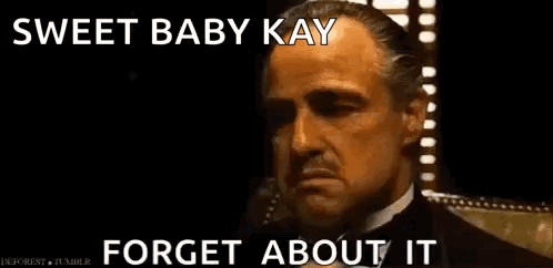 A Man In A Suit And Tie Is Talking On A Cell Phone And Says Sweet Baby Kay Forget About It . GIF