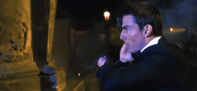A Man In A Suit And Tie Is Talking On A Cell Phone With The Word Abort Written Above Him GIF