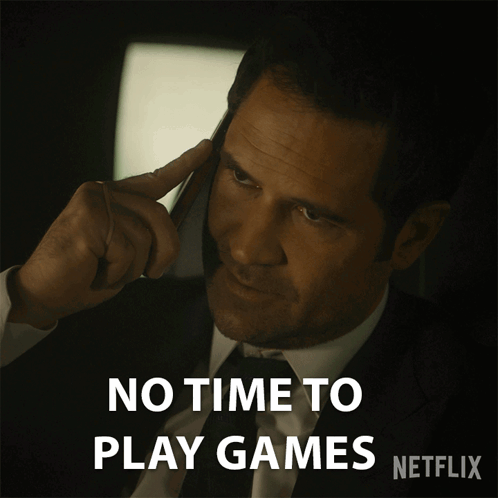 A Man In A Suit And Tie Is Talking On A Cell Phone With The Words " No Time To Play Games " Below Him GIF