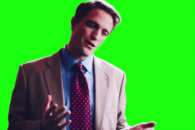 A Man In A Suit And Tie Is Talking On A Green Screen . GIF