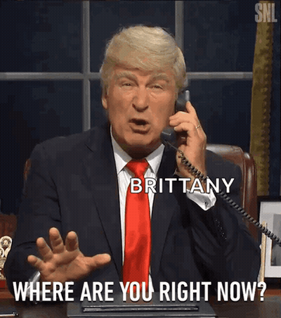 A Man In A Suit And Tie Is Talking On A Phone With Brittany Where Are You Right Now Written Below Him GIF