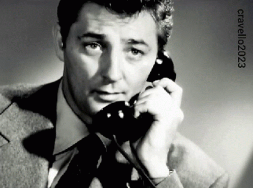 A Man In A Suit And Tie Is Talking On A Phone With The Year 2023 On The Bottom GIF