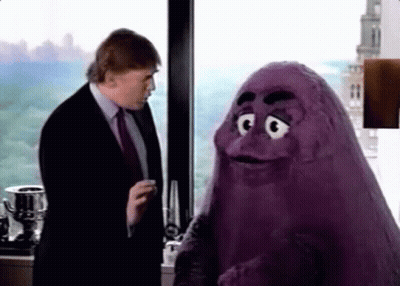 A Man In A Suit And Tie Is Talking To A Purple Monster In Front Of A Window . GIF