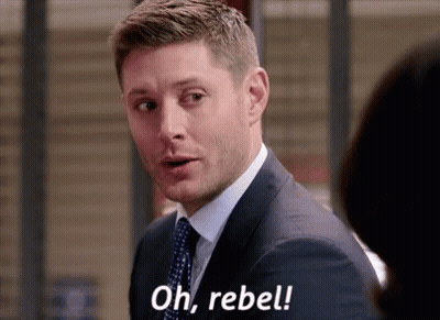 A Man In A Suit And Tie Is Talking To A Woman And Saying `` Oh , Rebel '' . GIF