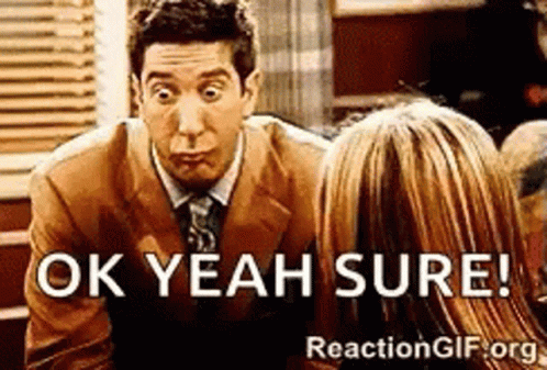 A Man In A Suit And Tie Is Talking To A Woman And Says Ok Yeah Sure GIF