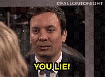 A Man In A Suit And Tie Is Talking To A Woman And Says `` You Lie '' . GIF