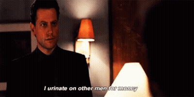 A Man In A Suit And Tie Is Talking To A Woman In A Room . GIF
