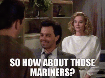 A Man In A Suit And Tie Is Talking To A Woman In A White Shirt While Another Man Looks On .. GIF