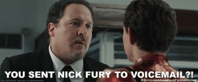 A Man In A Suit And Tie Is Talking To A Young Boy In A Spiderman Far From Home Poster GIF