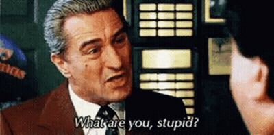 A Man In A Suit And Tie Is Talking To Another Man And Asking Him What Are You Stupid . GIF