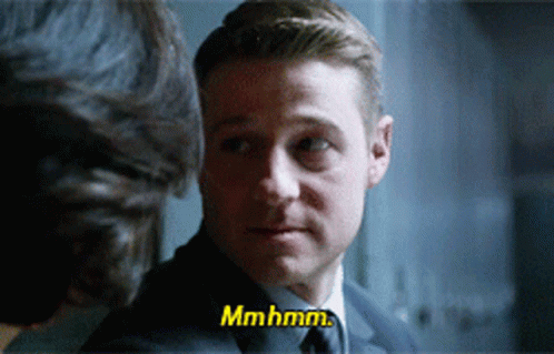 A Man In A Suit And Tie Is Talking To Another Man And Says Mmhmm GIF