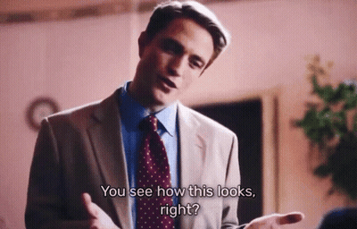 A Man In A Suit And Tie Is Talking To Another Man And Says " You See How This Looks Right " GIF