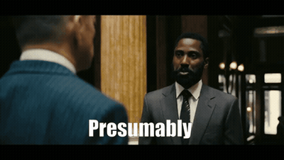 A Man In A Suit And Tie Is Talking To Another Man And The Words Presumably Are Visible GIF