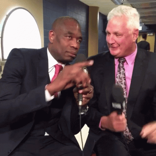 A Man In A Suit And Tie Is Talking To Another Man GIF