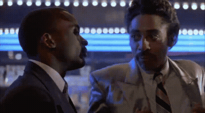 A Man In A Suit And Tie Is Talking To Another Man In A Suit And Tie . GIF