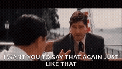 A Man In A Suit And Tie Is Talking To Another Man In A Suit And Tie . GIF