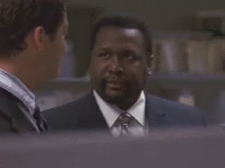 A Man In A Suit And Tie Is Talking To Another Man In A Suit And Tie . GIF