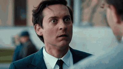 A Man In A Suit And Tie Is Talking To Another Man In A White Shirt . GIF