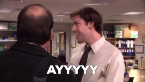A Man In A Suit And Tie Is Talking To Another Man In An Office And Saying Ayyyyyy . GIF