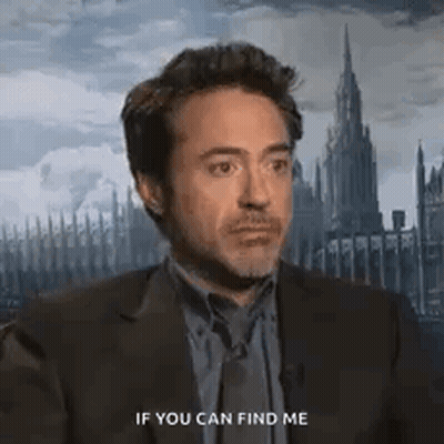 A Man In A Suit And Tie Is Talking To Another Man . GIF
