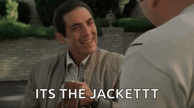 A Man In A Suit And Tie Is Talking To Another Man While Holding A Glass Of Beer . GIF