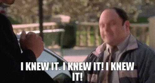 A Man In A Suit And Tie Is Talking To Another Man While Holding A Microphone . GIF
