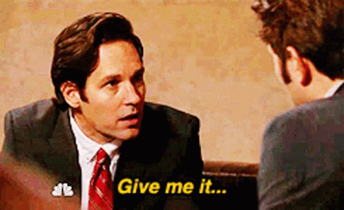 A Man In A Suit And Tie Is Talking To Another Man Who Is Saying Give Me It GIF