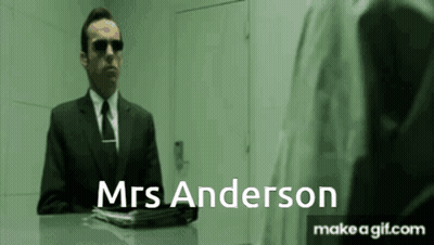 A Man In A Suit And Tie Is Talking To Mrs Anderson . GIF
