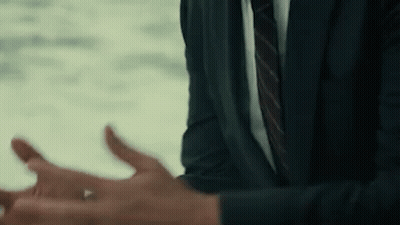 A Man In A Suit And Tie Is Talking To Someone . GIF