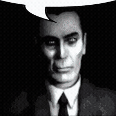 A Man In A Suit And Tie Is Talking With A Speech Bubble . GIF