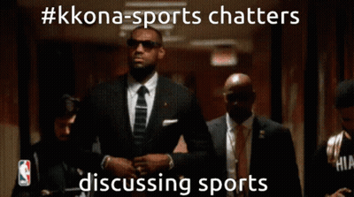 A Man In A Suit And Tie Is Walking Down A Hallway With A Caption That Says #Kkona-Sports Chatters GIF
