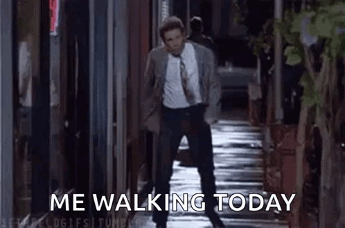 A Man In A Suit And Tie Is Walking Down A Sidewalk With The Words `` Me Walking Today '' . GIF