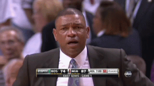 A Man In A Suit And Tie Is Watching A Game On Espn GIF