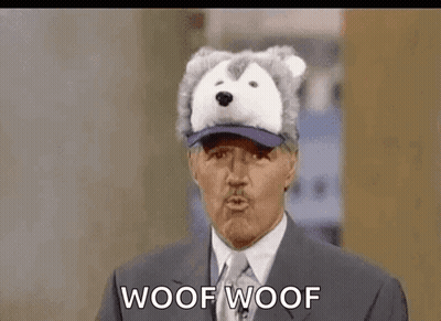 A Man In A Suit And Tie Is Wearing A Husky Hat And Talking . GIF