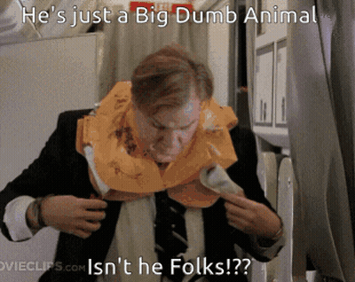 A Man In A Suit And Tie Is Wearing A Life Vest Around His Neck GIF
