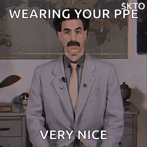 A Man In A Suit And Tie Is Wearing A Ppe And Is Very Nice GIF