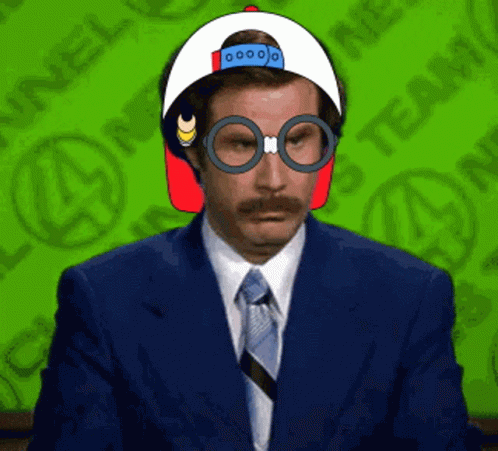 A Man In A Suit And Tie Is Wearing Glasses And A Hat GIF