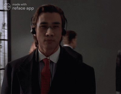 A Man In A Suit And Tie Is Wearing Headphones And A Reface App Logo GIF