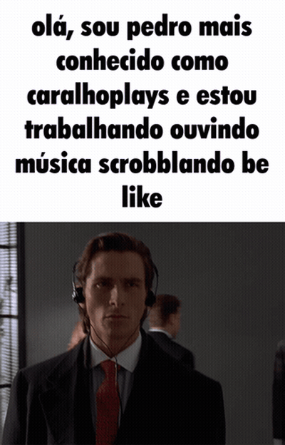 A Man In A Suit And Tie Is Wearing Headphones And Says " Olá " GIF