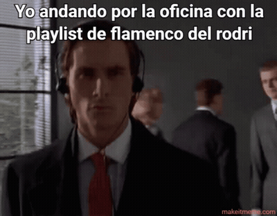 A Man In A Suit And Tie Is Wearing Headphones With The Caption Yo Andando Por La Oficina GIF