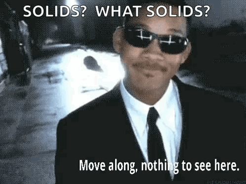 A Man In A Suit And Tie Is Wearing Sunglasses And A Caption That Says Solids What Solids Move Along Nothing To See Here GIF