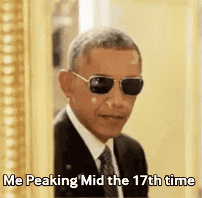 A Man In A Suit And Tie Is Wearing Sunglasses And Says " Me Peaking Mid The 17Th Time " GIF