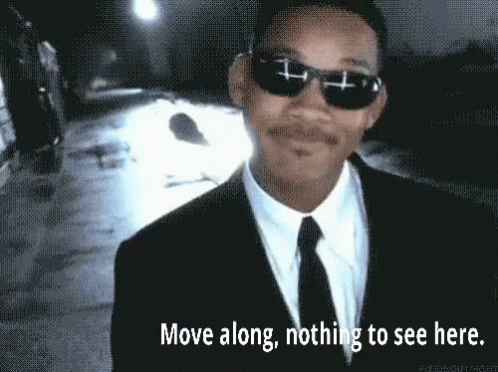 A Man In A Suit And Tie Is Wearing Sunglasses . GIF