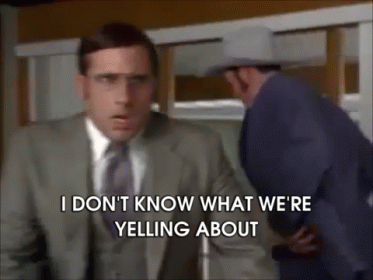 A Man In A Suit And Tie Is Yelling At Another Man GIF