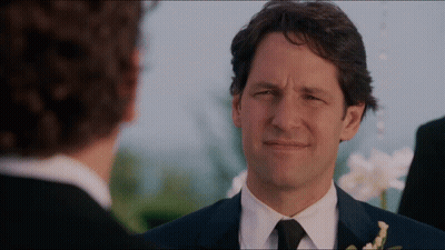 A Man In A Suit And Tie Looks At Another Man In A Black Suit GIF