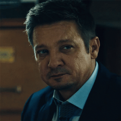 A Man In A Suit And Tie Looks At The Camera With A Serious Look On His Face GIF