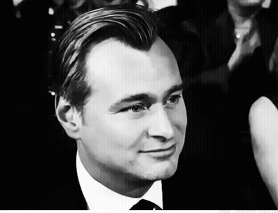 A Man In A Suit And Tie Looks At The Camera GIF