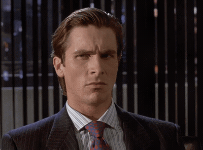 A Man In A Suit And Tie Looks Serious GIF